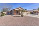Single-story home featuring a low-maintenance desert landscape, covered porch, and a two-car garage at 21181 N 80Th Ln, Peoria, AZ 85382