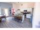 Open-concept kitchen featuring an island with bar seating, stainless appliances, and wood plank flooring at 21181 N 80Th Ln, Peoria, AZ 85382