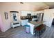 Modern kitchen with granite countertops, white cabinets, stainless steel appliances, and wood-look floors at 21181 N 80Th Ln, Peoria, AZ 85382