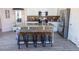Kitchen featuring an island with bar stools, granite countertops, and stainless steel appliances at 21181 N 80Th Ln, Peoria, AZ 85382