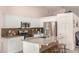 Bright kitchen with white cabinets, stainless steel appliances, granite countertops, and a charming wood-look backsplash at 21181 N 80Th Ln, Peoria, AZ 85382