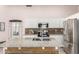 A spacious kitchen featuring granite countertops, white cabinets, stainless steel appliances, and a kitchen island at 21181 N 80Th Ln, Peoria, AZ 85382