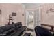 Inviting living room featuring a black futon, stylish decor, and access to a well-lit area beyond at 21181 N 80Th Ln, Peoria, AZ 85382