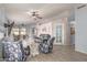 Inviting living room featuring tile floors, comfortable furnishings, and a view into the adjacent dining area at 21181 N 80Th Ln, Peoria, AZ 85382