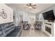 Cozy living room with wood-look tile flooring, a decorative fireplace, and comfortable seating arrangements at 21181 N 80Th Ln, Peoria, AZ 85382