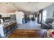Spacious living room featuring hardwood-style flooring, light-colored walls, and an open floorplan to the kitchen at 21181 N 80Th Ln, Peoria, AZ 85382