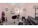 Charming living area featuring a black leather futon, a salon chair, and soft, inviting pastel colored walls at 21181 N 80Th Ln, Peoria, AZ 85382