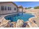 Backyard with a large pool, desert landscaping and view of the home's exterior and patio at 21181 N 80Th Ln, Peoria, AZ 85382