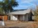 Charming home exterior with a wooden fence, under a clear blue sky at 2206 N 11Th St, Phoenix, AZ 85006