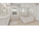 An elegant bathroom featuring a glass-enclosed shower with marble surround and quartz countertops at 22660 E Pegasus Pkwy, Queen Creek, AZ 85142