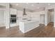 A modern kitchen featuring bright white cabinets, an island and recessed lighting at 22660 E Pegasus Pkwy, Queen Creek, AZ 85142