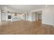 Spacious living room featuring sleek wood floors and an open concept design to the kitchen at 22660 E Pegasus Pkwy, Queen Creek, AZ 85142