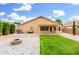 The backyard with low-maintenance landscaping includes a fire pit and covered patio for relaxing outside at 2300 E Austin Dr, Gilbert, AZ 85296