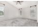 Spacious bedroom with neutral carpet, fan and light fixture, and bright, airy windows at 2300 E Austin Dr, Gilbert, AZ 85296