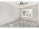 This bedroom has a window for natural light and a ceiling fan for efficient cooling during warmer weather at 2300 E Austin Dr, Gilbert, AZ 85296