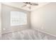 This carpeted bedroom is naturally lit by a shuttered window and contains electrical outlets in view at 2300 E Austin Dr, Gilbert, AZ 85296