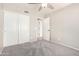 This bedroom contains standard closet doors, access to another room, and a ceiling fan at 2300 E Austin Dr, Gilbert, AZ 85296