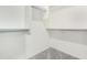This walk-in closet features neutral colors, shelves, and metal rails for optimal storage organization and design at 2300 E Austin Dr, Gilbert, AZ 85296