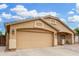 Close-up of the home featuring a two-car garage, neutral exterior, and desert landscaping at 2300 E Austin Dr, Gilbert, AZ 85296