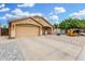 Well-maintained single-story home featuring a two-car garage, neutral exterior, and desert landscaping at 2300 E Austin Dr, Gilbert, AZ 85296