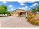 Well-maintained single-story home featuring a two-car garage, neutral exterior, and desert landscaping at 2300 E Austin Dr, Gilbert, AZ 85296