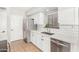 Kitchen features stainless steel appliances, modern sink, white cabinets, and subway tile backsplash at 2300 E Austin Dr, Gilbert, AZ 85296