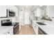 Clean kitchen features white cabinets, stainless steel appliances and sink, and bright lighting at 2300 E Austin Dr, Gilbert, AZ 85296