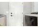 This functional laundry room includes modern appliances, a white door, and gray-painted walls at 2300 E Austin Dr, Gilbert, AZ 85296
