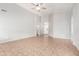 Open living room with tile floors, vaulted ceilings, and a ceiling fan creating a bright, airy atmosphere at 2300 E Austin Dr, Gilbert, AZ 85296