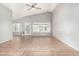 Bright living room featuring tile floors, high ceilings, and multiple windows for ample natural light at 2300 E Austin Dr, Gilbert, AZ 85296
