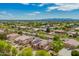 An aerial view of a neighborhood of houses in a green desert environment at 24916 N 80Th Ln, Peoria, AZ 85383
