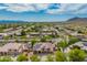 Houses with solar panels in a desert community with mountains in the distance at 24916 N 80Th Ln, Peoria, AZ 85383