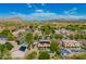 Desert neighborhood with multiple homes, each featuring outdoor pools at 24916 N 80Th Ln, Peoria, AZ 85383