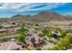 Aerial view of desert neighborhood with mountains in the background and houses with solar panels at 24916 N 80Th Ln, Peoria, AZ 85383