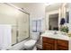 A functional bathroom features a shower-tub combination, toilet, and vanity with ample counter space at 24916 N 80Th Ln, Peoria, AZ 85383