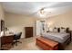 A comfortable bedroom features a ceiling fan, bed, desk, and dresser at 24916 N 80Th Ln, Peoria, AZ 85383