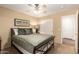 A bedroom featuring a bed, ceiling fan, closet and hardwood floors outside the room at 24916 N 80Th Ln, Peoria, AZ 85383