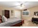 A bedroom with a ceiling fan, closet, desk and bookcase at 24916 N 80Th Ln, Peoria, AZ 85383