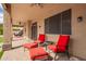 Relaxing covered patio with comfortable seating, ceiling fans, and exterior lighting at 24916 N 80Th Ln, Peoria, AZ 85383
