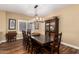 Well-lit dining room with dark wood table, chandelier, and modern decor at 24916 N 80Th Ln, Peoria, AZ 85383