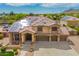 Elegant two-story home with tile roof, solar panels, three-car garage, and inviting front porch with seating at 24916 N 80Th Ln, Peoria, AZ 85383