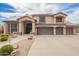 Charming two-story home with a three-car garage, covered entry, tile roof, and desert landscaping at 24916 N 80Th Ln, Peoria, AZ 85383
