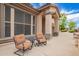 Inviting front porch with comfortable seating, attractive columns, and a welcoming entrance to the home at 24916 N 80Th Ln, Peoria, AZ 85383
