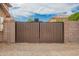 Wooden driveway gate for added privacy and security at 24916 N 80Th Ln, Peoria, AZ 85383