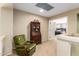 A cozy landing with a comfortable chair and view of a bedroom at 24916 N 80Th Ln, Peoria, AZ 85383