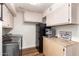 Bright laundry room with a refrigerator, countertop, storage cabinets, and stainless steel washer and dryer at 24916 N 80Th Ln, Peoria, AZ 85383