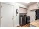 Bright laundry room boasts stainless steel washer, dryer, and ample cabinet storage at 24916 N 80Th Ln, Peoria, AZ 85383