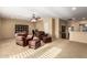 Spacious living room with neutral carpeting, plush seating, and a bright, airy atmosphere at 24916 N 80Th Ln, Peoria, AZ 85383