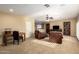 Spacious living room featuring neutral carpeting, plush leather seating, and natural light at 24916 N 80Th Ln, Peoria, AZ 85383