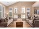 Bright living room with vaulted ceiling, wood floors, fireplace, and neutral decor at 24916 N 80Th Ln, Peoria, AZ 85383